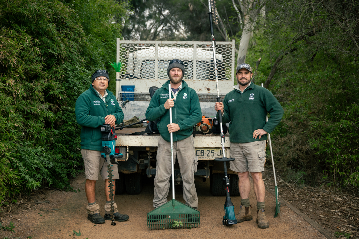 Three gardeners with equipment in front of van in Dubbo Zoo