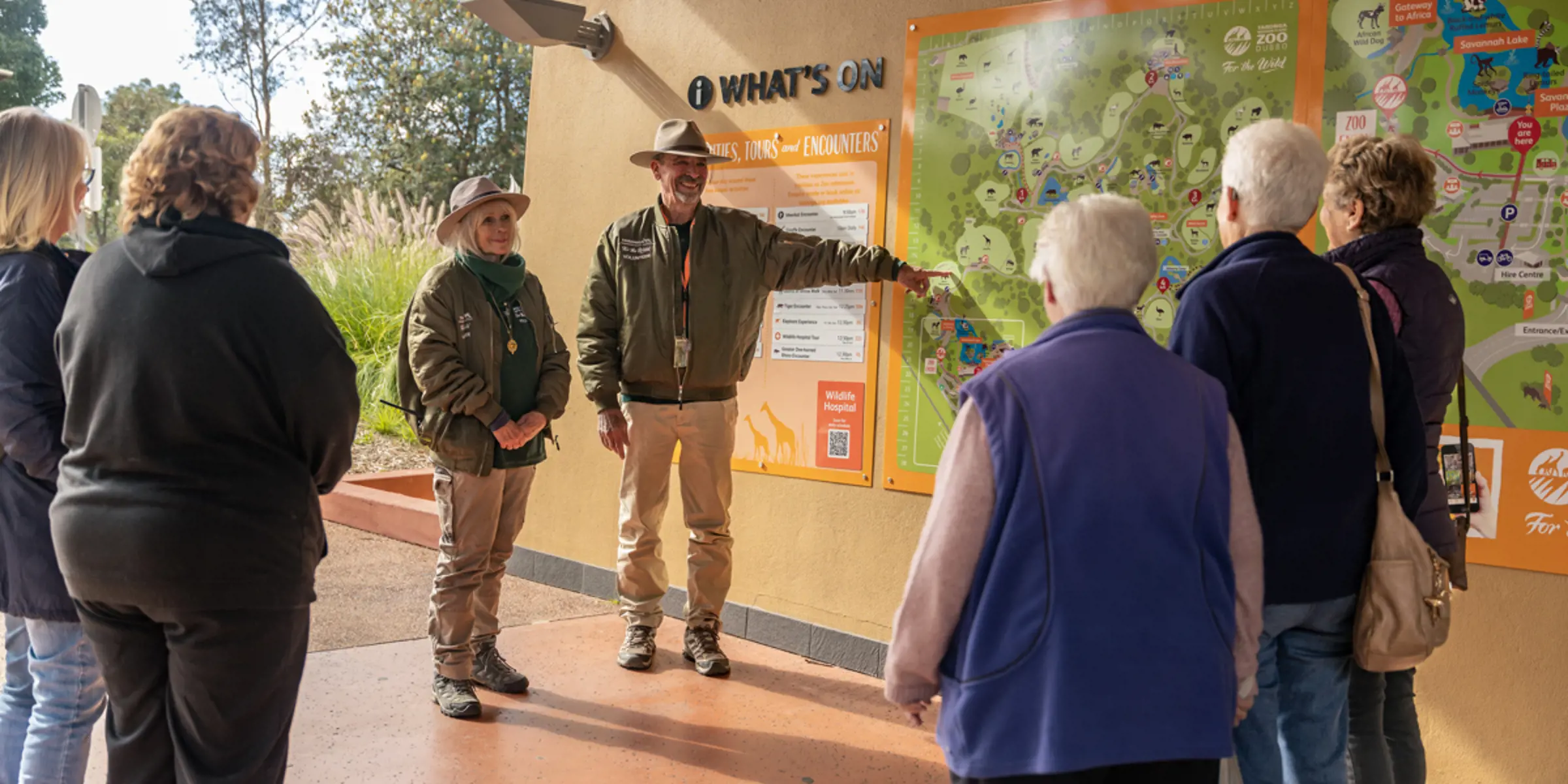 Group of guests being shown the large Taronga Western Plains map on the wall