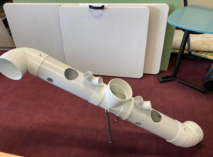 STEM enrichment device for meerkats designed by school students using PVC pipe.
