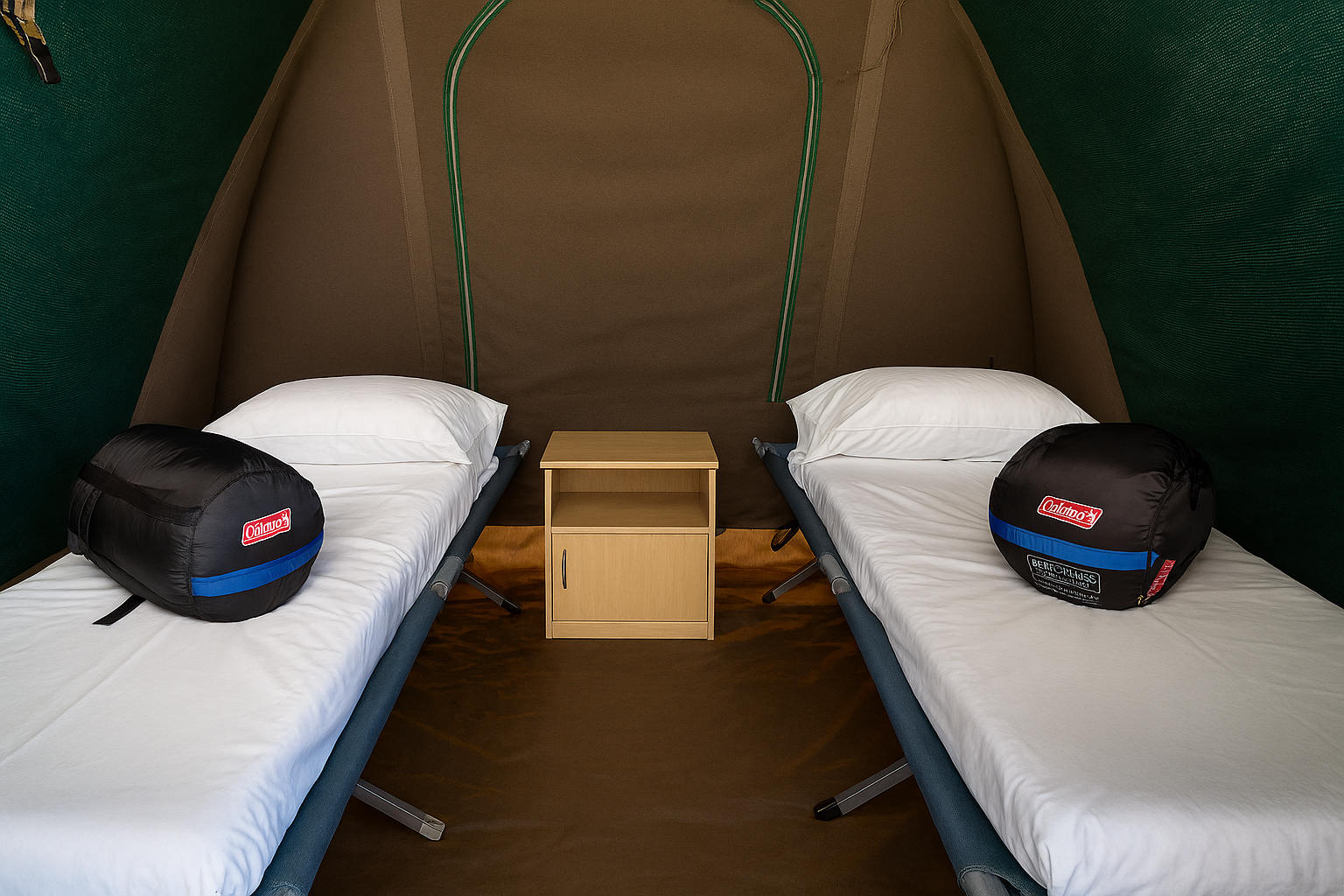 Interior of a safari‑style tent with sleeping bags on two single beds.